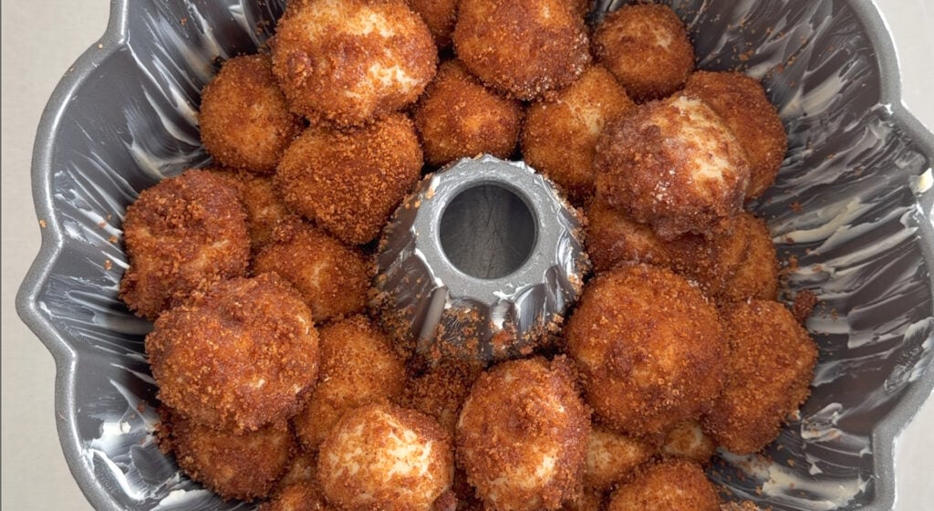 stacking the dough balls in a bundt pan