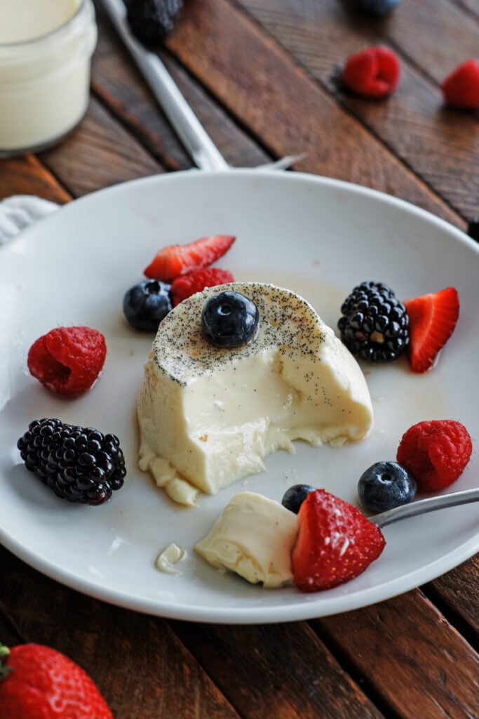 spoonful of panna cotta with berries