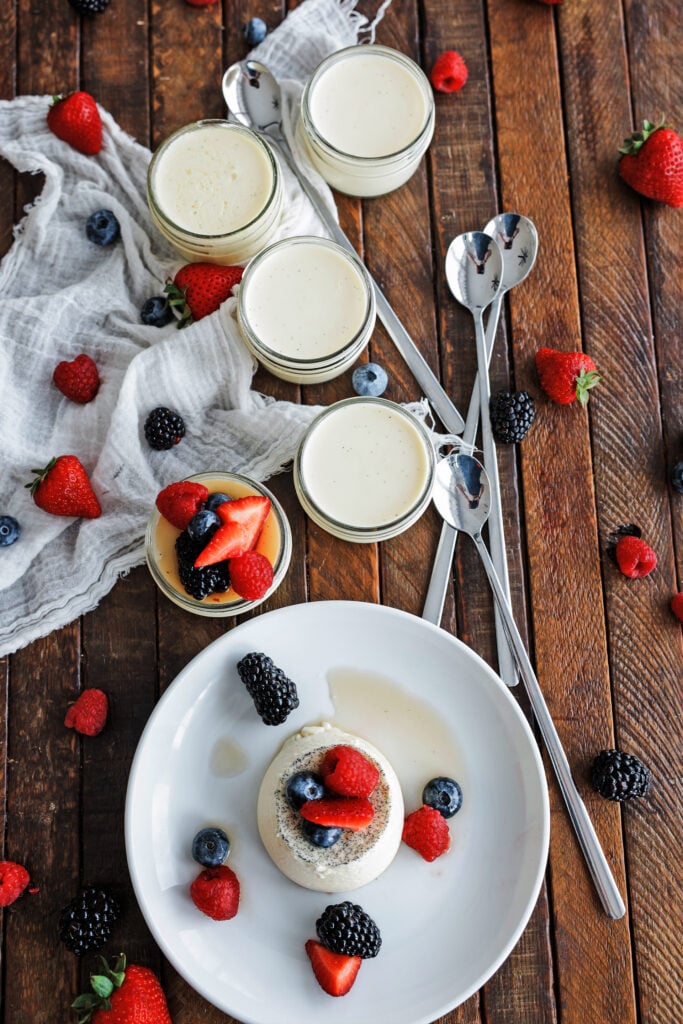 five ramekins of panna cotta with berries