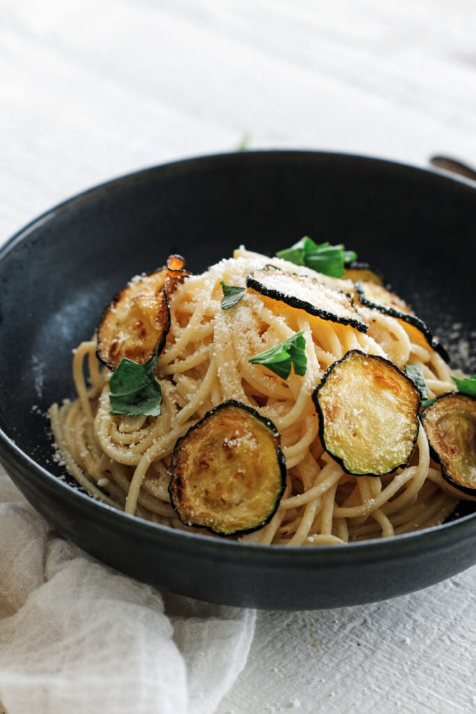 Spaghetti alla nerano served on a black plate
