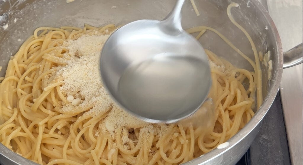 adding the pasta water to the pasta