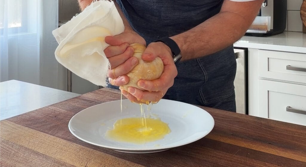 Draining the pumpkin puree with a cheesecloth