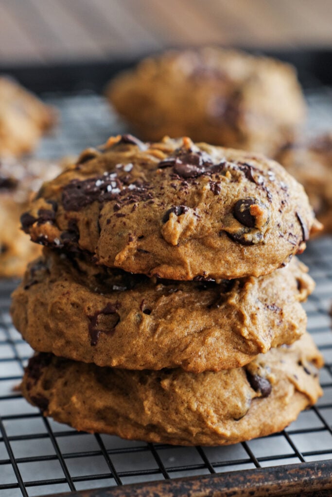 Pumpkin chocolate chip cookies stacked on top of each other.