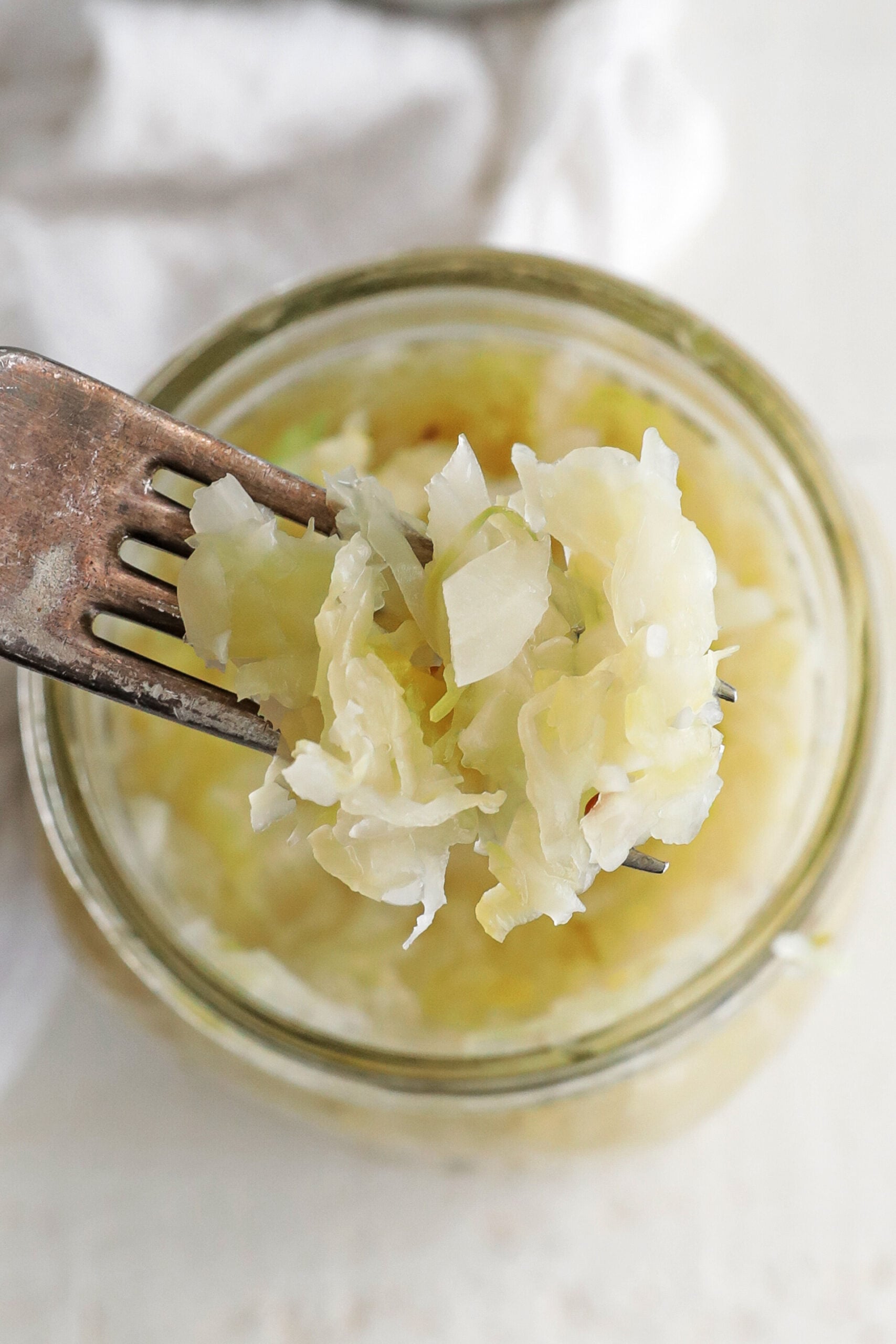a fork full of sauerkraut from a jar