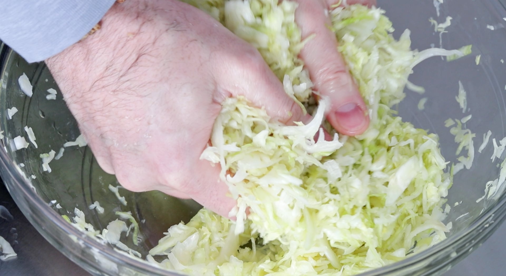 mixing cabbage and salt