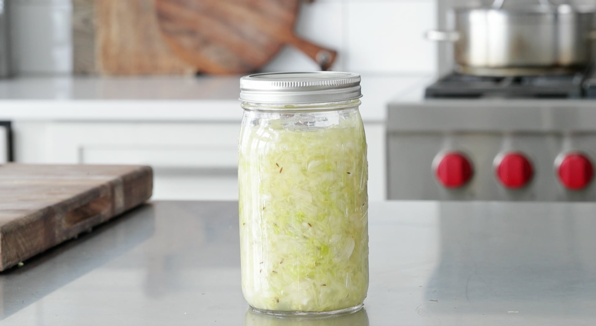 sealing a jar of sauerkraut
