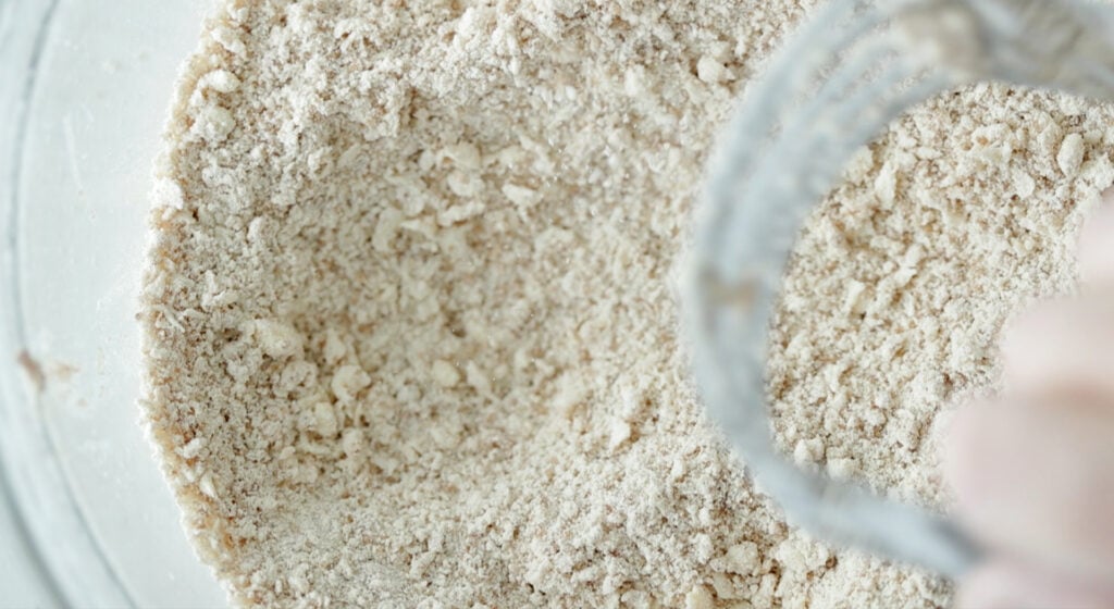 making a streusel topping in a bowl with a pastry knife