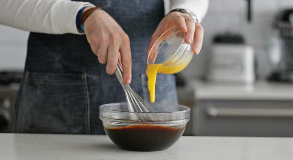 whisking molasses in a large bowl