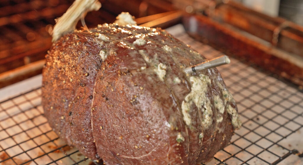 coating the roast in the Dijon herb butter