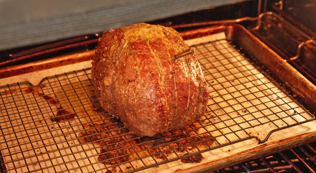 cooked sirloin tip roast resting on a tray