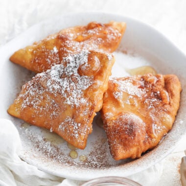 sopapilla on a plate with honey