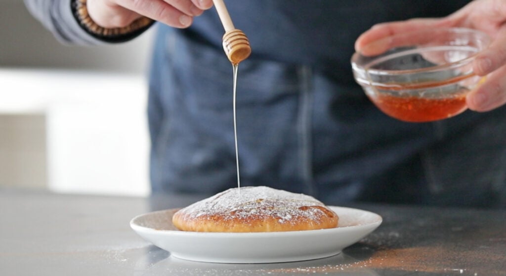 adding honey to a sopapilla