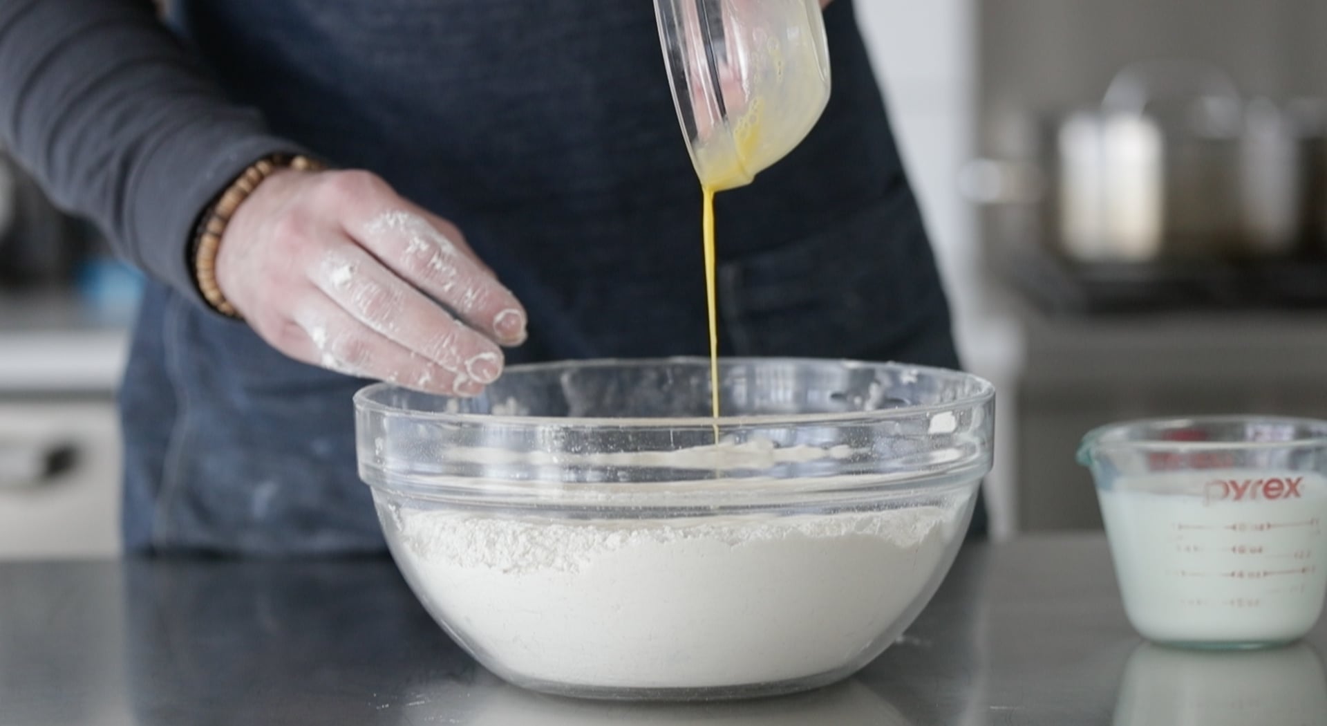adding an egg to flour