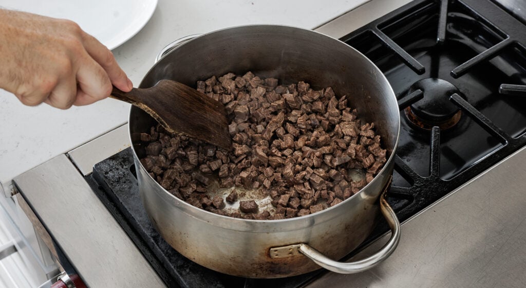 searing the beef in a pot