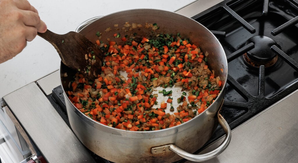 cooking the peppers and garlic with beef
