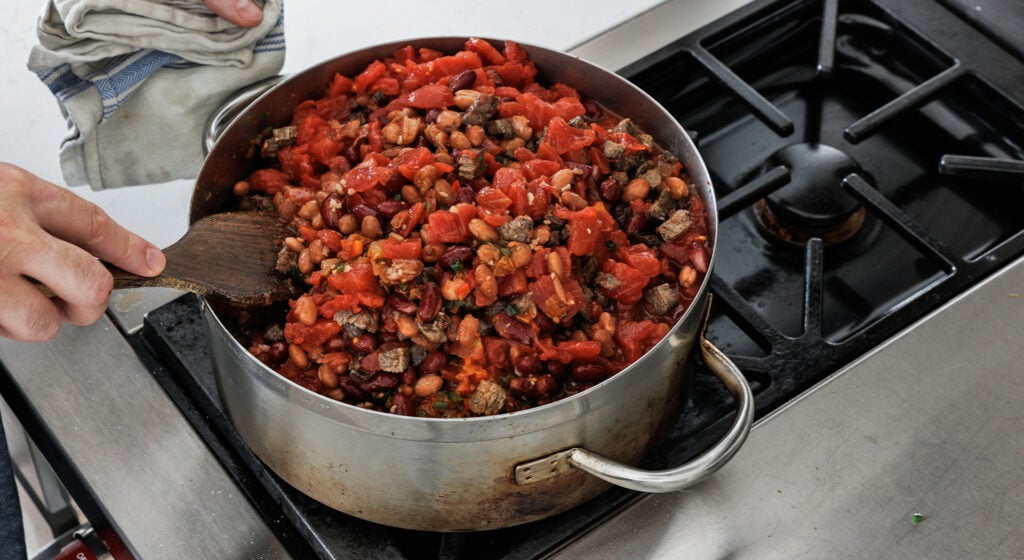 stirring the tomato paste and spices