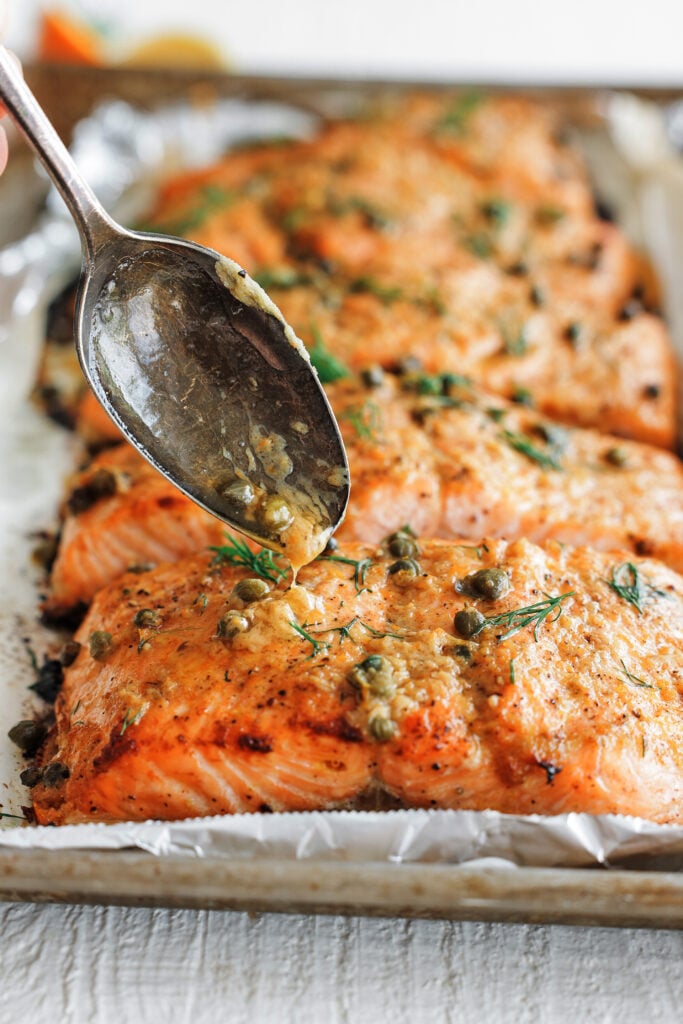 Skin-on baked salmon fillets topped with fresh dill