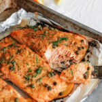 a forkful of baked salmon fillets topped with fresh dill