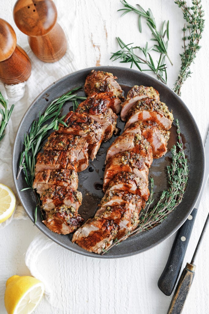 Sliced balsamic glazed pork tenderloin drizzled with sweet balsamic glaze