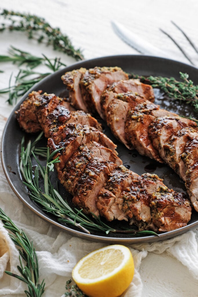 Sliced balsamic glazed pork tenderloin drizzled with sweet balsamic glaze