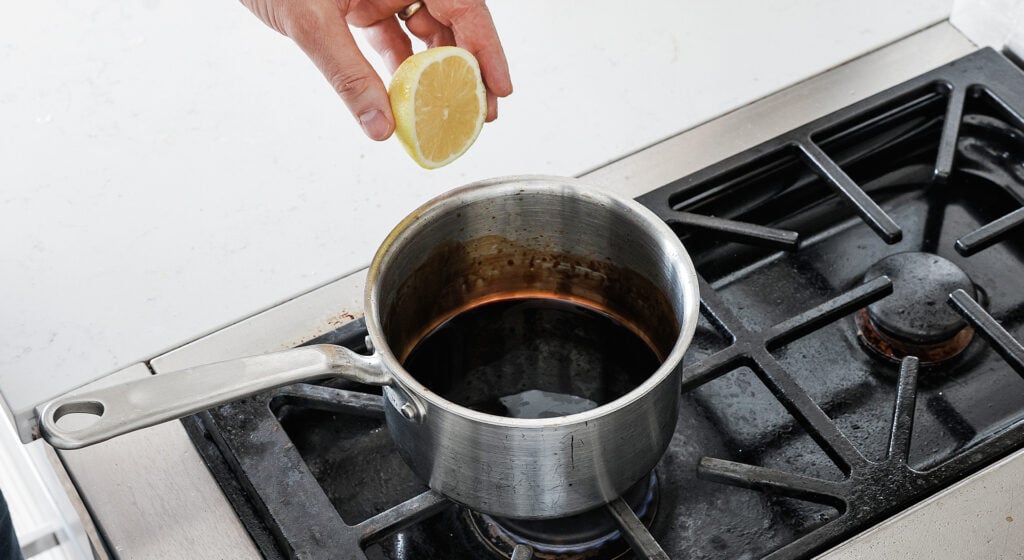 Balsamic vinegar and soy sauce reducing in a saucepot