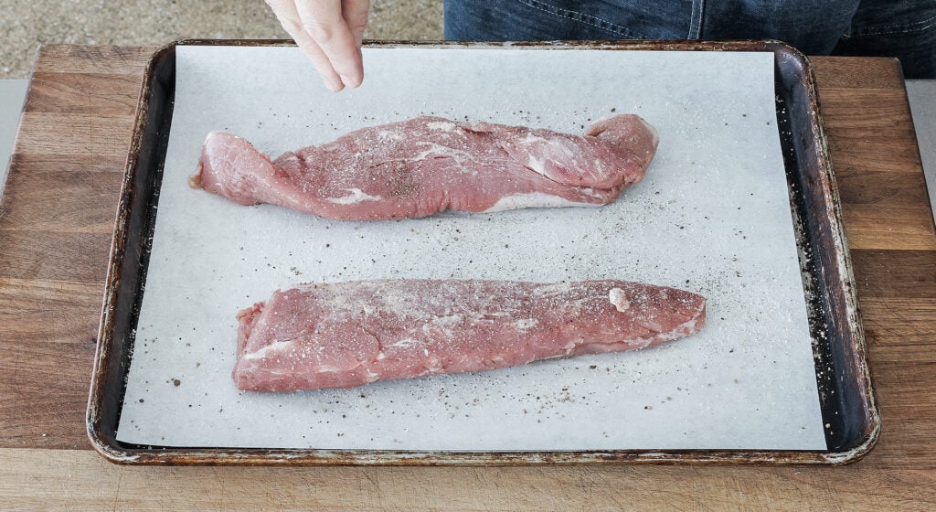 Two pork tenderloins patted dry and seasoned with kosher salt and black pepper
