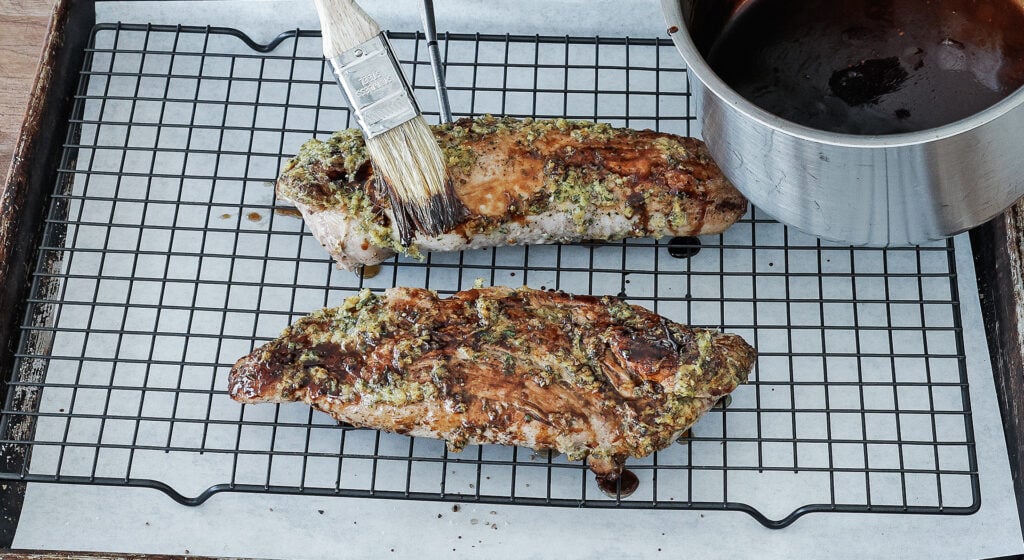 balsamic glaze is brushed over the top of the tenderloin