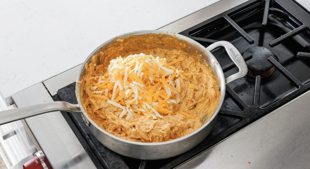 Shredded cheddar and Monterey Jack folded into the buffalo chicken dip base