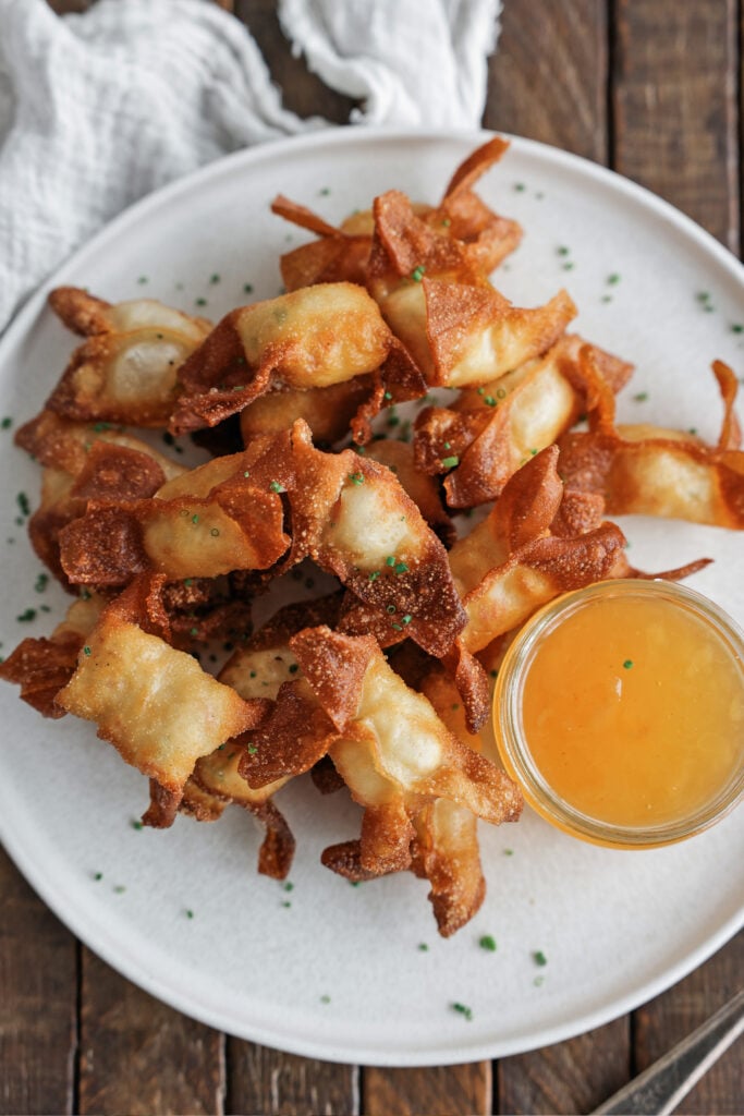 crab ragoon serve on a plate with sauce