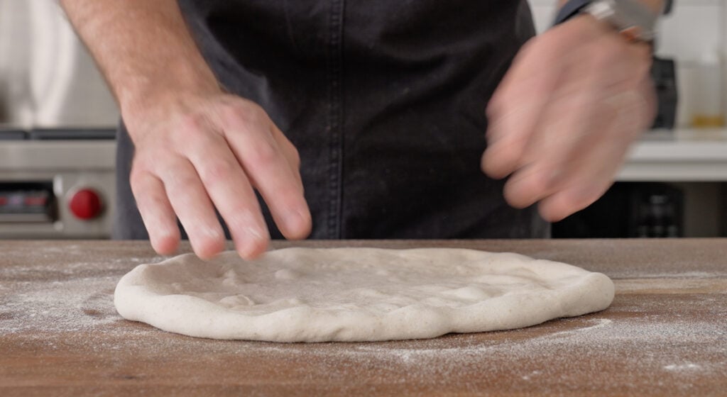 Stretching the dough over semola