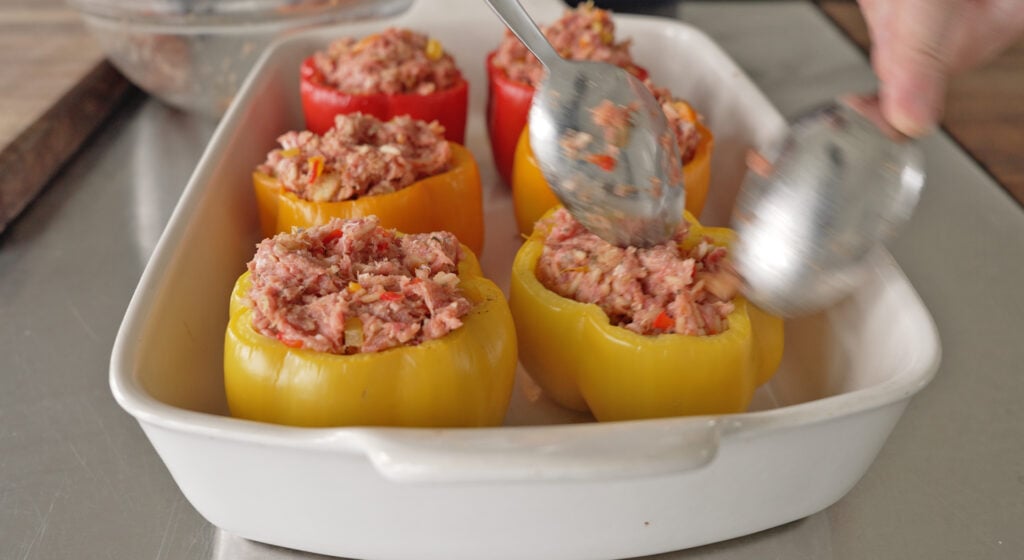 sweet peppers mounded full of the meat filling in the casserole dish
