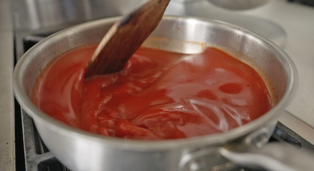beef stock and tomato puree simmering
